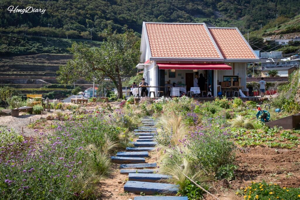 Cafe Tol exterior view surrounded by lush garden in Namhae