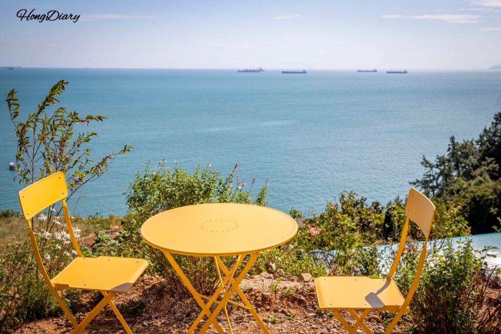 Outdoor table at Cafe Tol with panoramic ocean view in Namhae