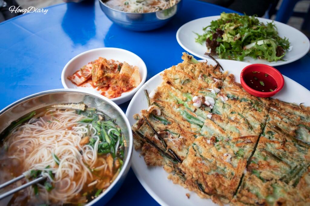 Snack stall near Seokbulsa public parking lot serving janchi guksu noodles and pajeon pancake
