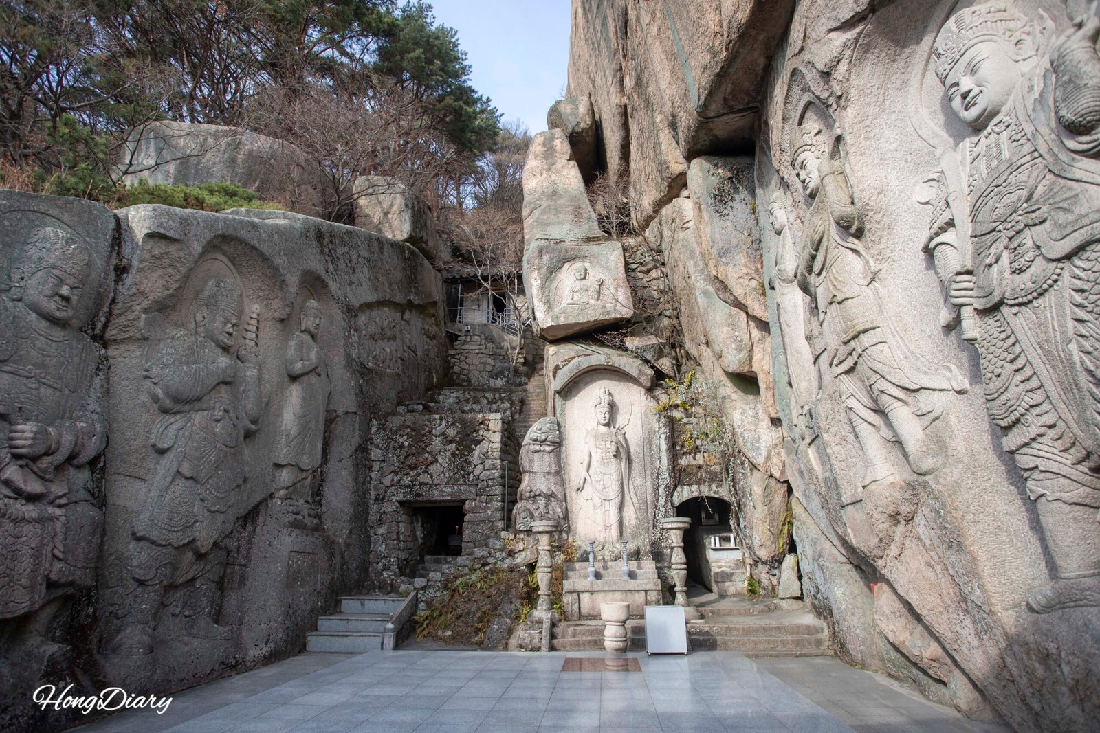 Stone Buddha figures carved into the cliff face at Seokbulsa Temple, Busan