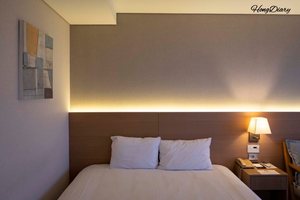 Guest room bed at Astar Hotel, Jeju City