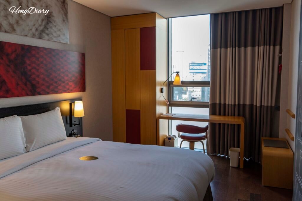 Standard room interior at Central Seven Hotel Busan with hardwood floors