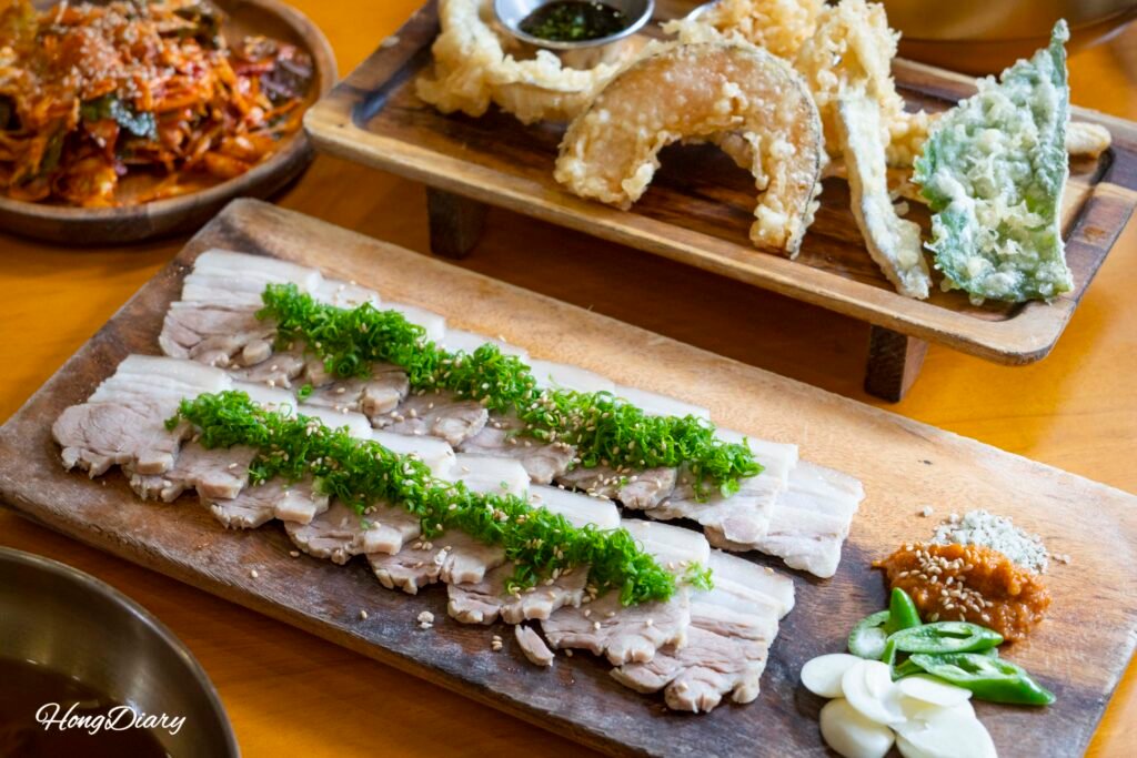 Jeju-style boiled pork (dombe) served at Go Guksu