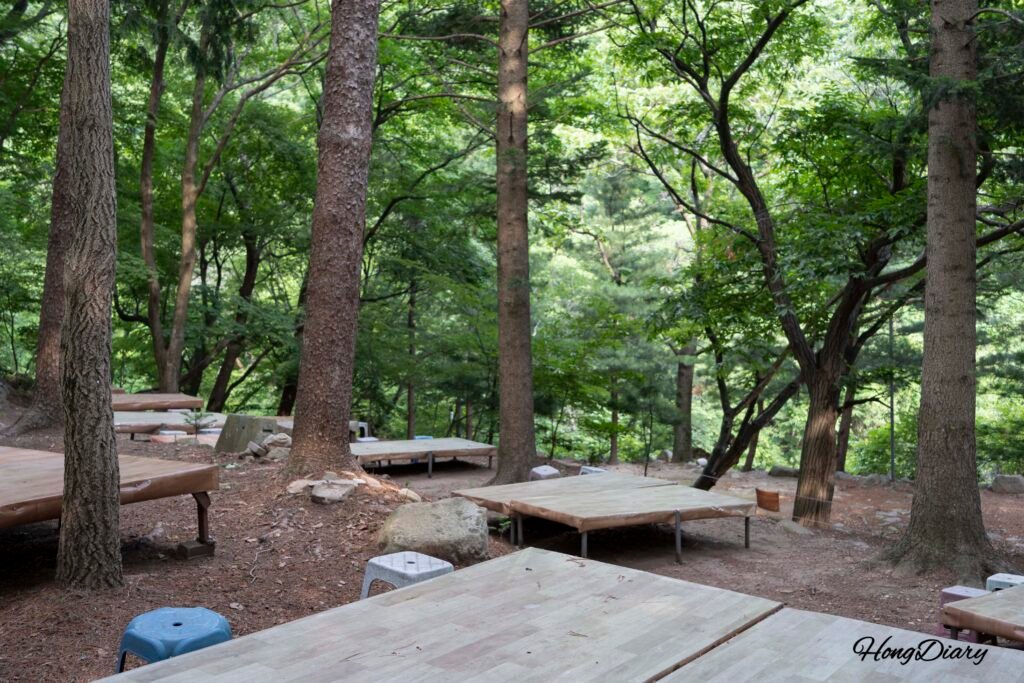 Outdoor platform seating near stream at Hobakso Valley Miryang entrance