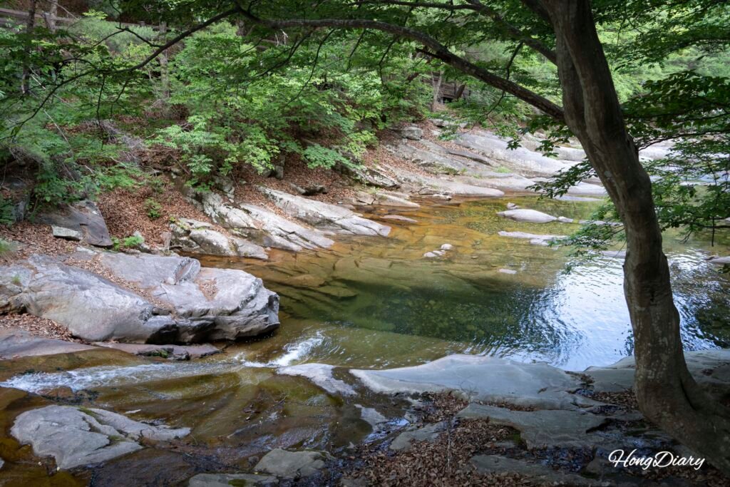 Rocky stream valley at Hobakso Miryang with trees and flowing water