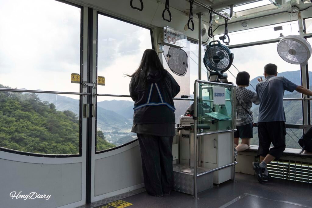 Interior of Ice Valley Cable Car cabin with full glass front wall and mountain views