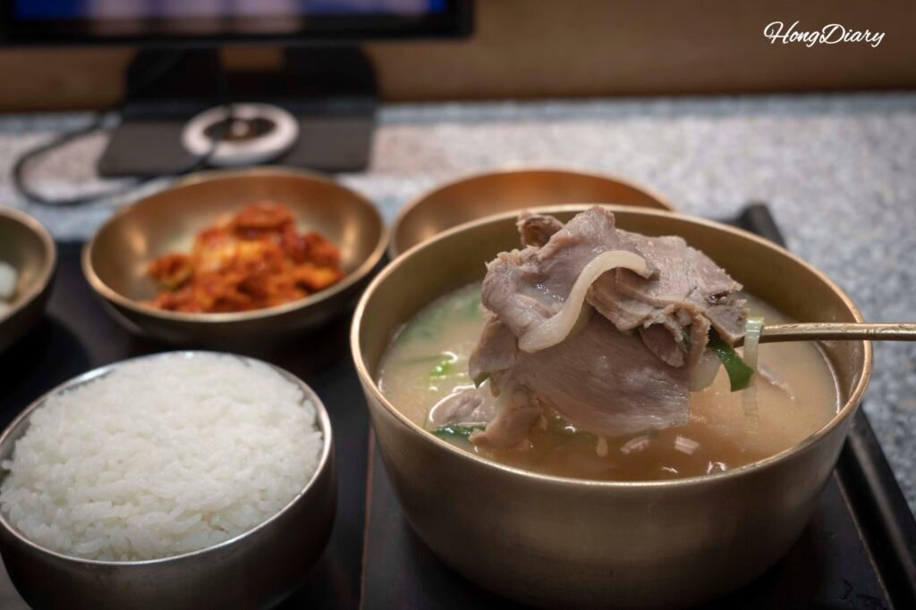 Generous pork pieces in dwaeji gukbap bowl at Jeongjitgan Busan Station Michelin restaurant
