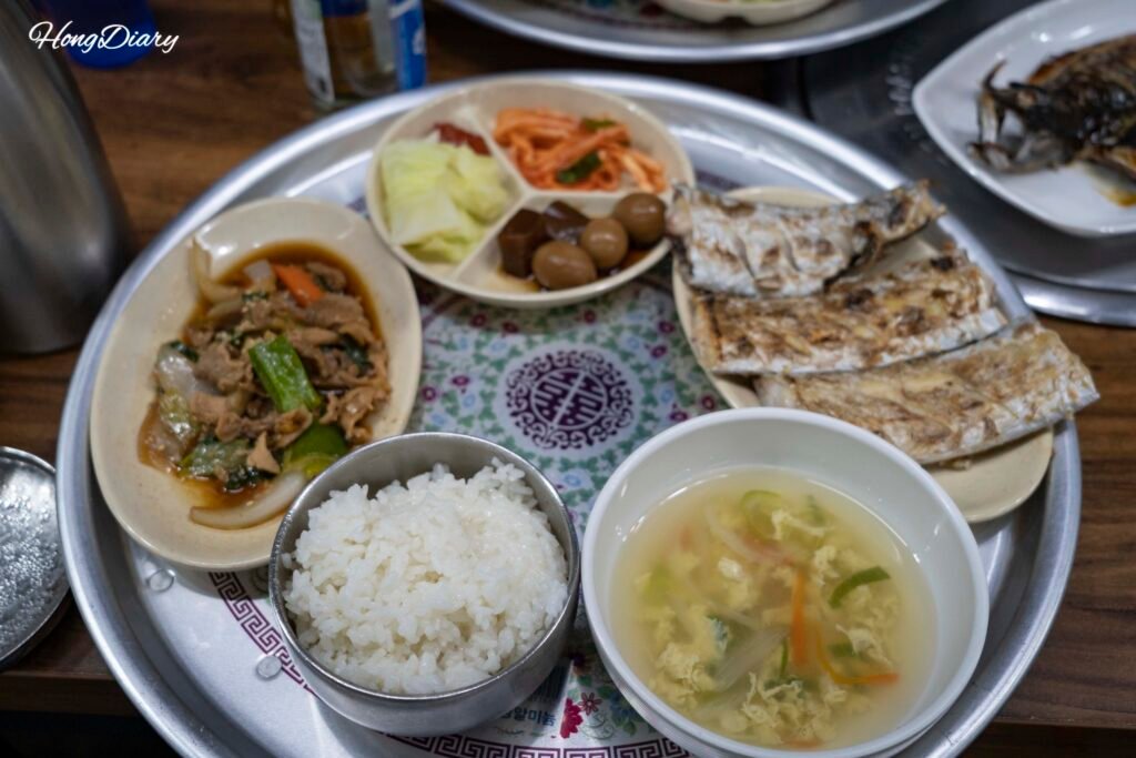 Grilled fish set meal on a retro tray at Nammae Wang Galchi, Jeju