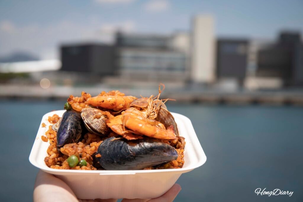 Gijang anchovy paella from Sehoskitchen with Busan harbor in background