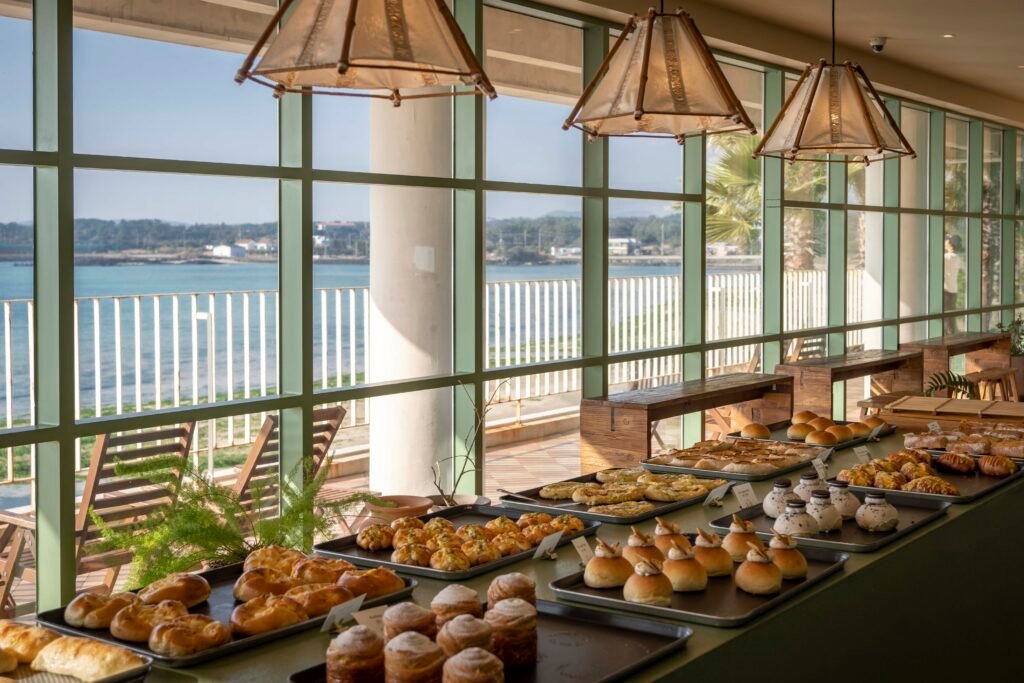 Seating area with panoramic ocean view at Seogwipean Bakery, Jeju