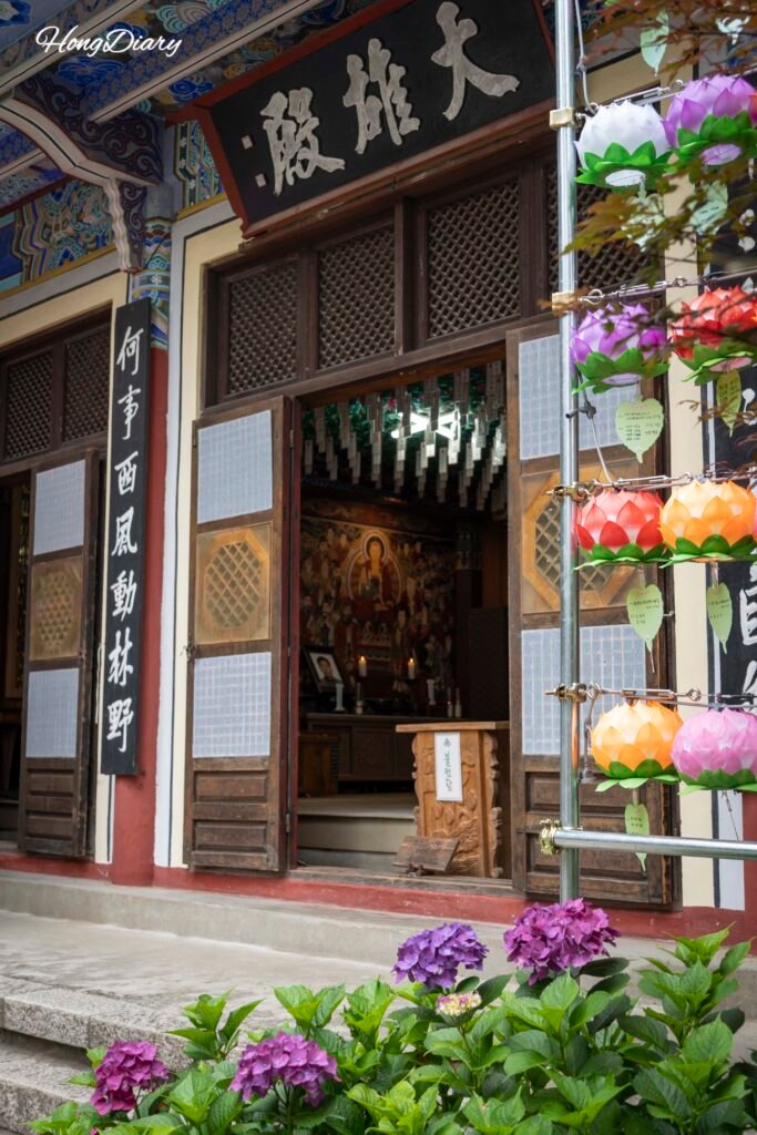 Taejongsa Temple main hall surrounded by hydrangeas in Yeongdo Busan