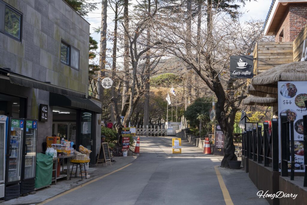 Entrance to Beopgi Reservoir with cafes and shops along the path in Dong-myeon, Yangsan