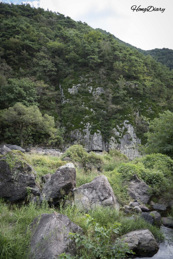 Panoramic view of Binggye Valley with steep volcanic cliffs and Ssanggyecheon stream