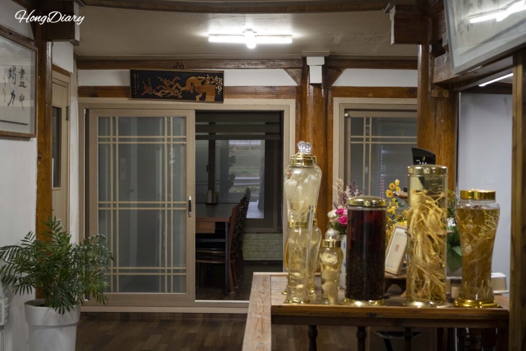 Interior of Gangbyeon Garden restaurant with a bottle of ginseng wine (insam-ju) visible on the table