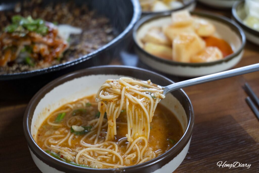 Close-up of eojuk showing the thick porridge texture with noodles and dissolved fish broth