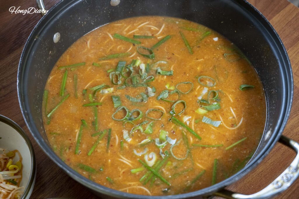 Eojuk (freshwater fish porridge) served bubbling in a stone pot at Gangbyeon Garden, Geumsan