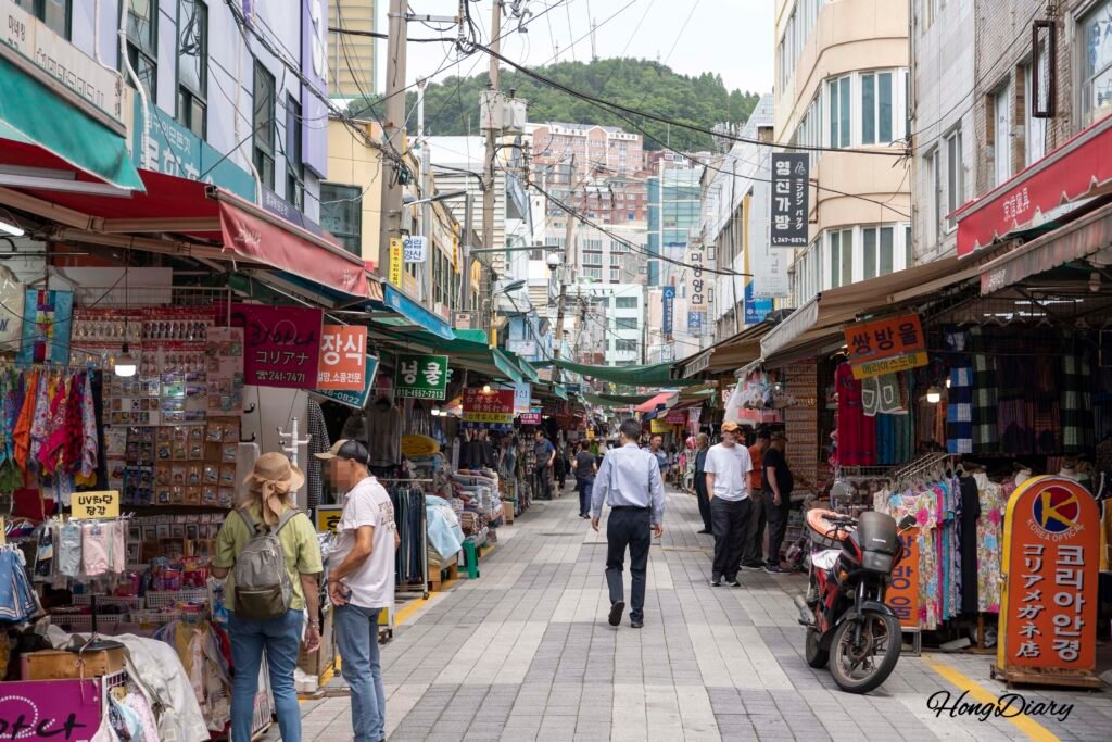 Shoppers walking through the alleys of Gukje Market in Busan