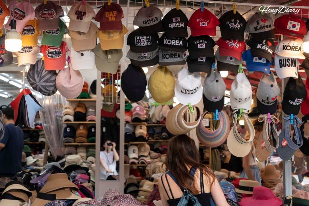 Souvenir shops inside Gukje Market selling K-pop merchandise and Korean goods