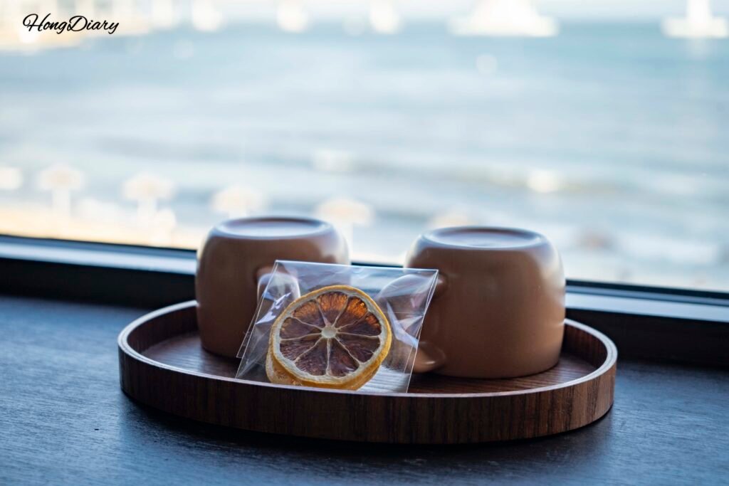 Complimentary dried fruit tea and ceramic cup set by the window at Gwangalli W Hotel