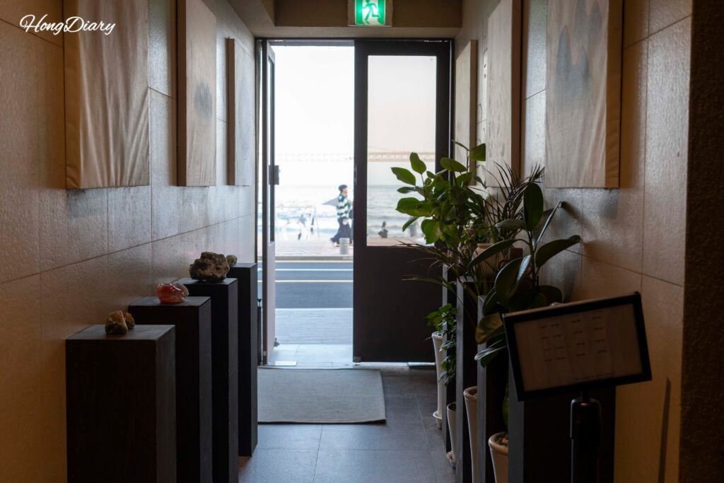 Clean, warmly lit hallway inside Gwangalli W Hotel in Busan
