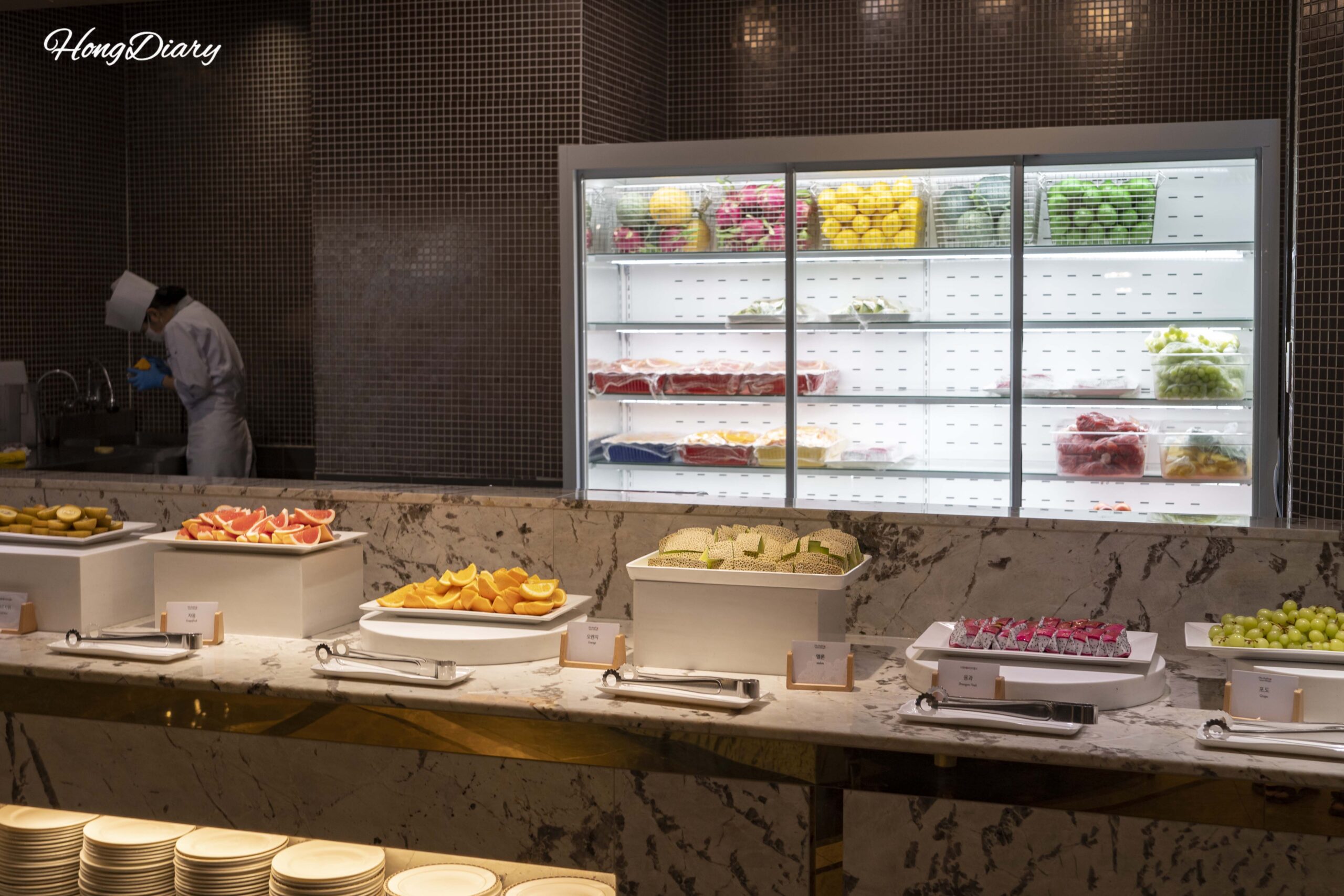 Estación de frutas frescas en The Buffet at Inter-Burgo Daegu con kiwi, melón y uva shine muscat
