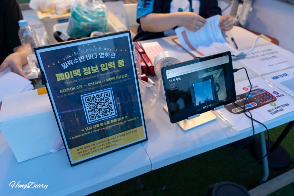 Payback refund booth at Millak Ocean Cinema where visitors submit paper receipts