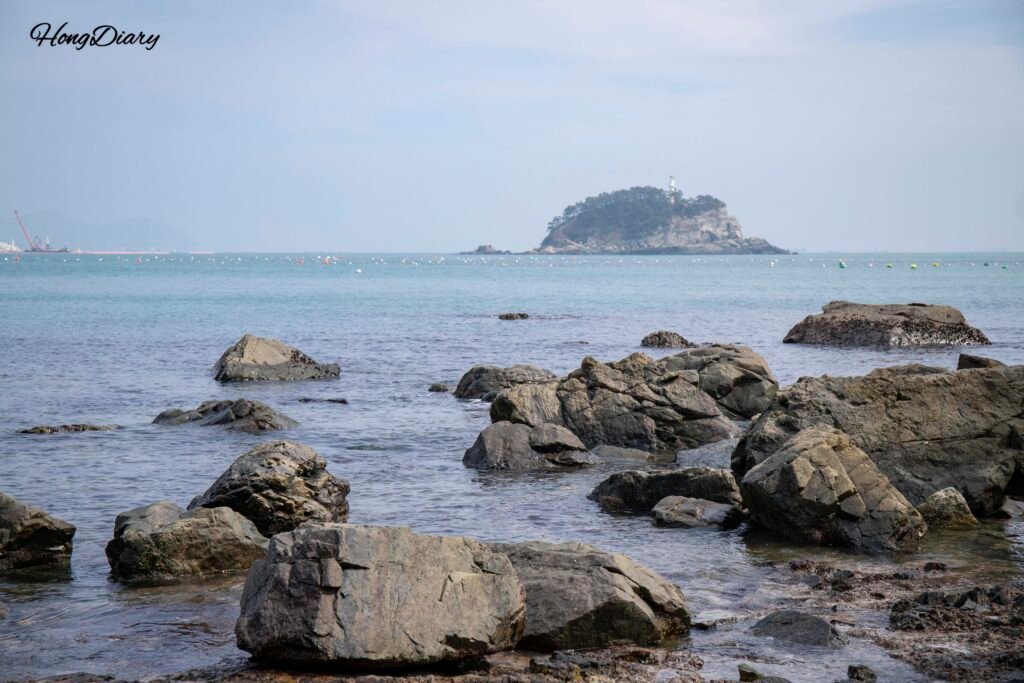 Clear water and rocky shoreline at the hidden beach below Molundae Trail, Busan