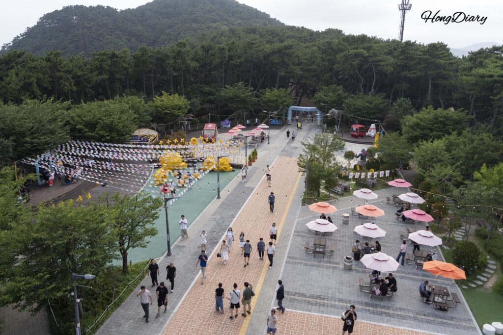 Park Square plaza at Songdo Sky Park viewed from the rooftop, with rest areas and sculptures in Busan