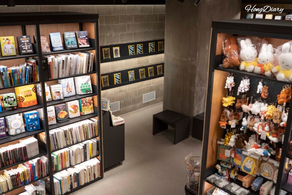 Interior of Arc N Book Gwangalli branch at Podium Dive, with styled bookshelves and warm lighting