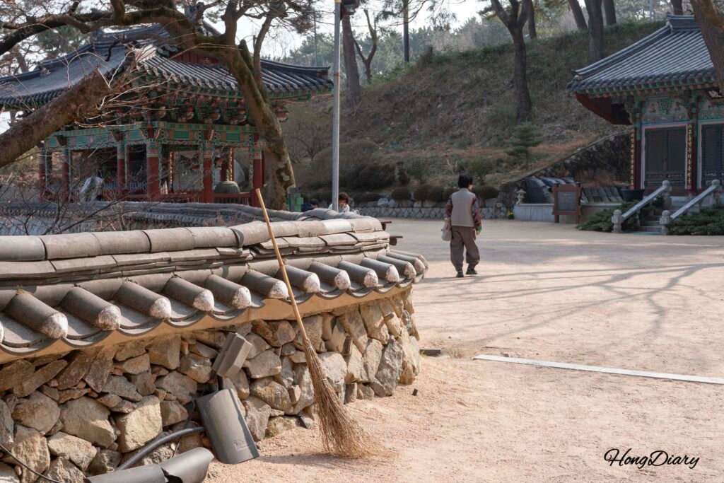 A visitor walking through the quiet grounds of Seonamsa Temple in Busanjin-gu, Busan