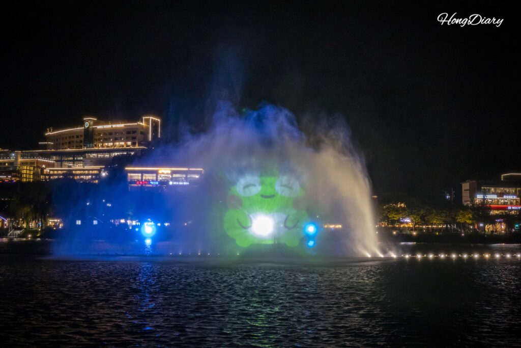 Close-up of the illuminated music fountain at Suseongmot during the nighttime main show