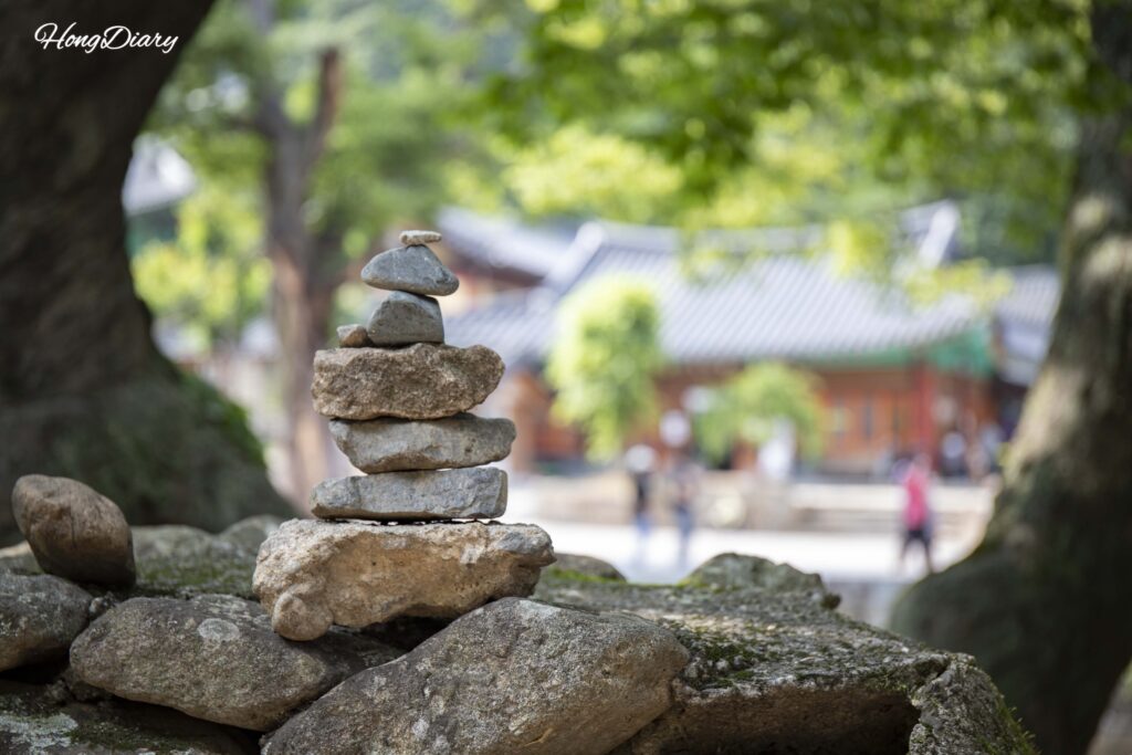 Small stone cairns stacked by visitors along the trail at Tongdosa Temple