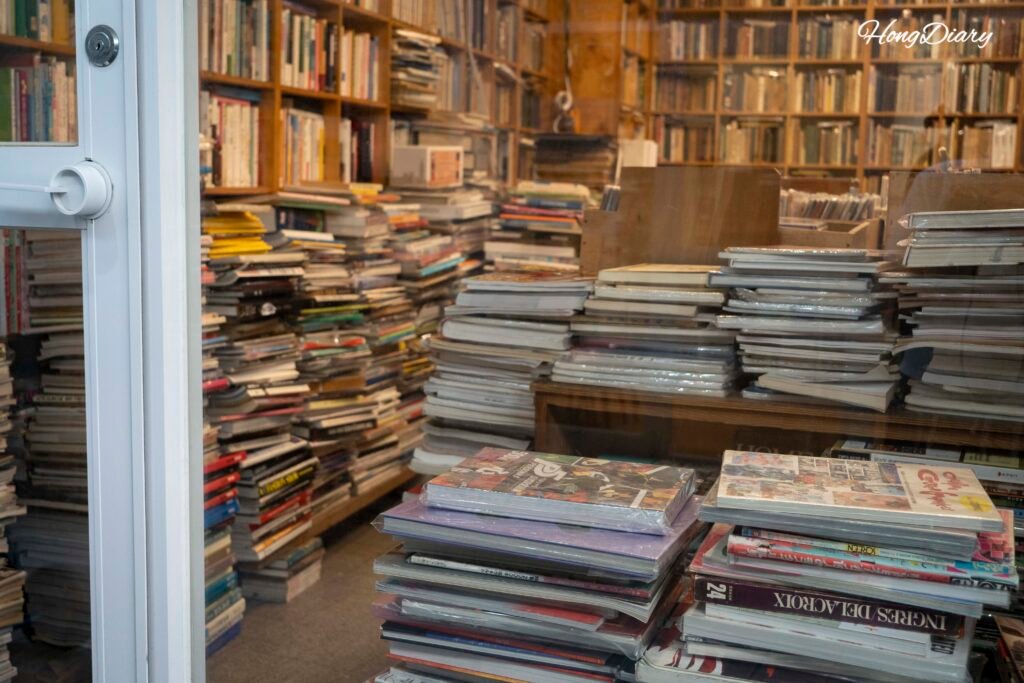 Piles of used books displayed outside a shop at Bosu-dong Book Street in Busan