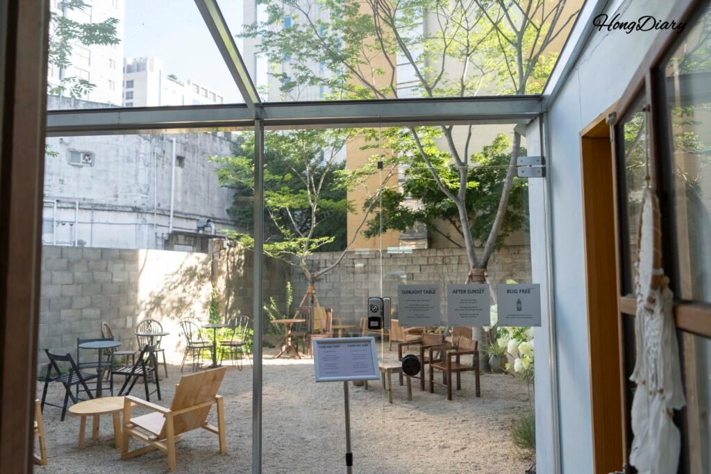 Hidden garden courtyard behind VACA Coffee Lounge in Gwangalli, Busan with greenery and seating