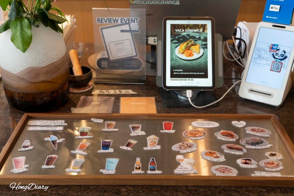 Hand-drawn menu board at the order counter of VACA Coffee Lounge Gwangalli