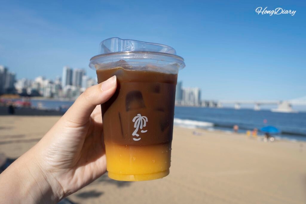 Takeout cup of Orange Americano, the signature drink at VACA Coffee Lounge Gwangalli