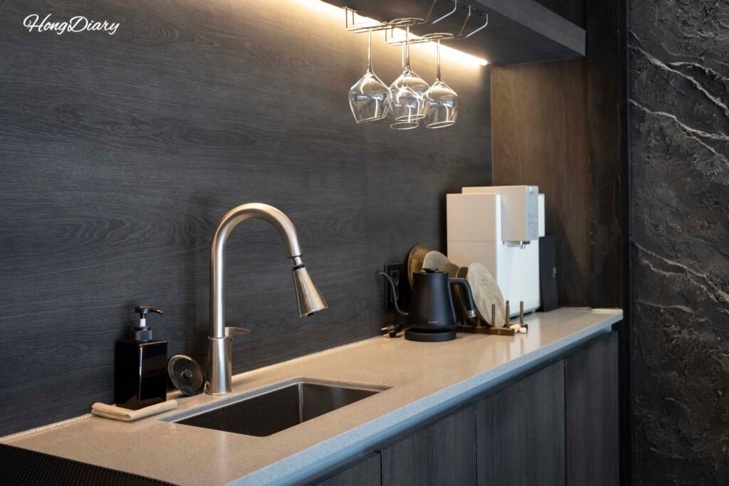 Cocina equipada con copas de vino, purificador de agua y vajilla de cerámica en Yeojuhyeon
