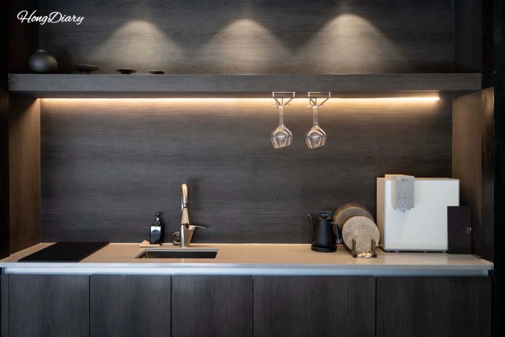 Fully equipped kitchen with wine glasses, water purifier, and ceramic dishware at Yeojuhyeon