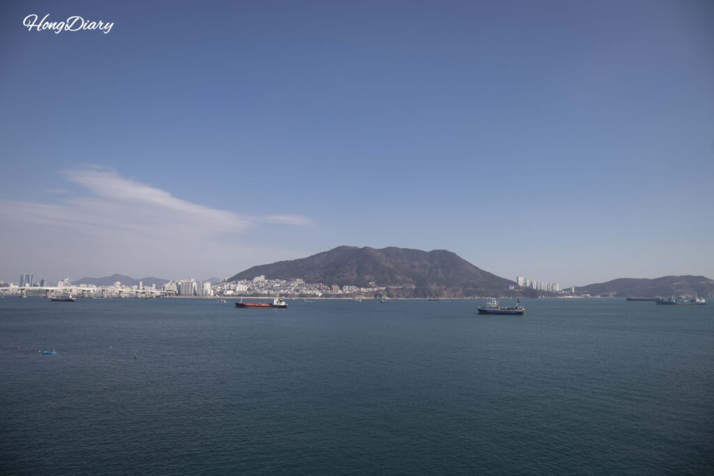 Open sea and rocky cliffs seen from the Songdo Yonggung Cloud Bridge, Busan