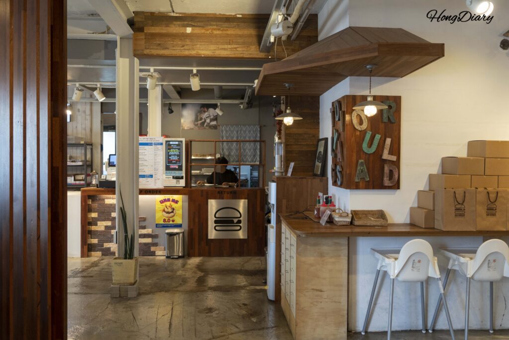 Interior decor details at Bao Burger Songjeong with natural wood finishes and soft lighting