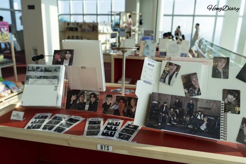 Close-up of K-pop idol merchandise and photo cards on display at Busan X the Sky