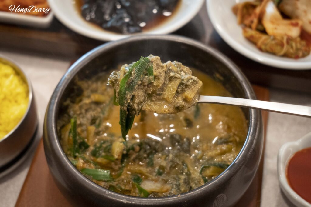 Close-up of sangwhang mushroom chueotang (Korean loach soup) bubbling in a stone pot at Irojeong Gumi