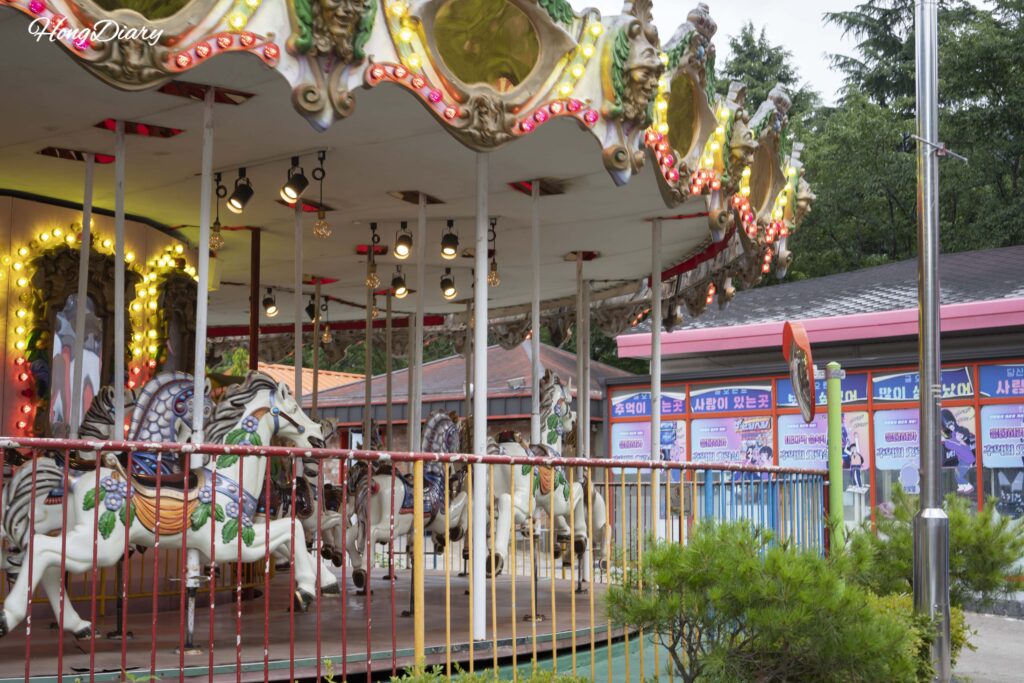 Carousel ride at Geumo Land with mountain in the background
