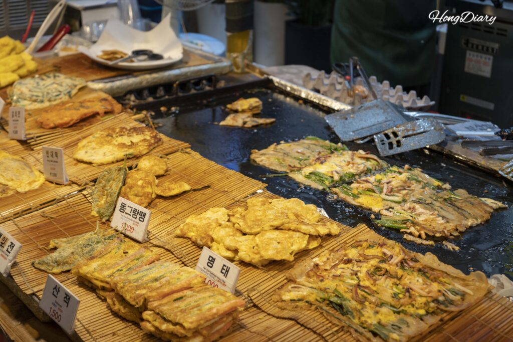 Stacks of assorted jeon (Korean savory pancakes) at Haeundae Traditional Market