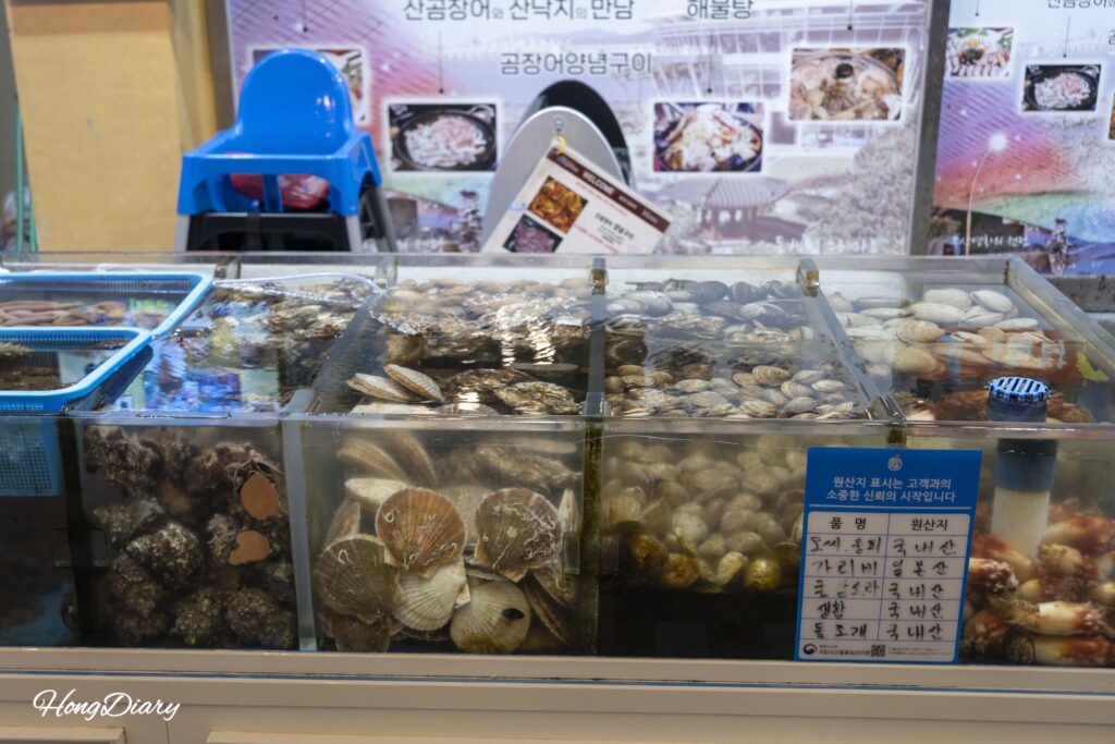 Live seafood tanks at a restaurant inside Haeundae Traditional Market
