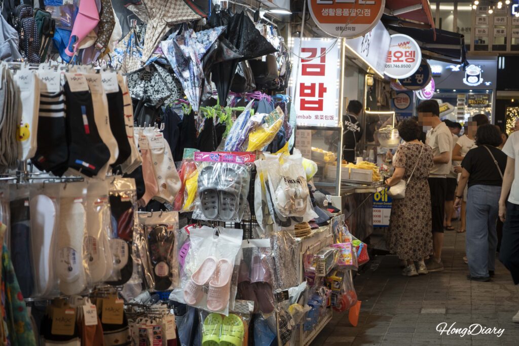 Street food stalls lining the alley of Haeundae Traditional Market at night