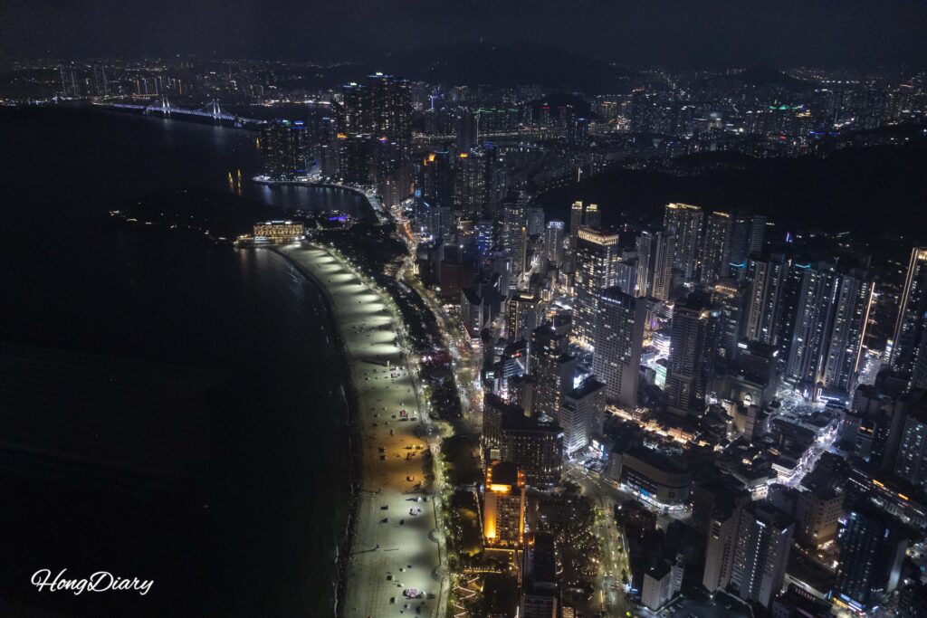 Night view of Haeundae Beach and Gwangan Bridge seen from the 98th floor of Busan X the Sky