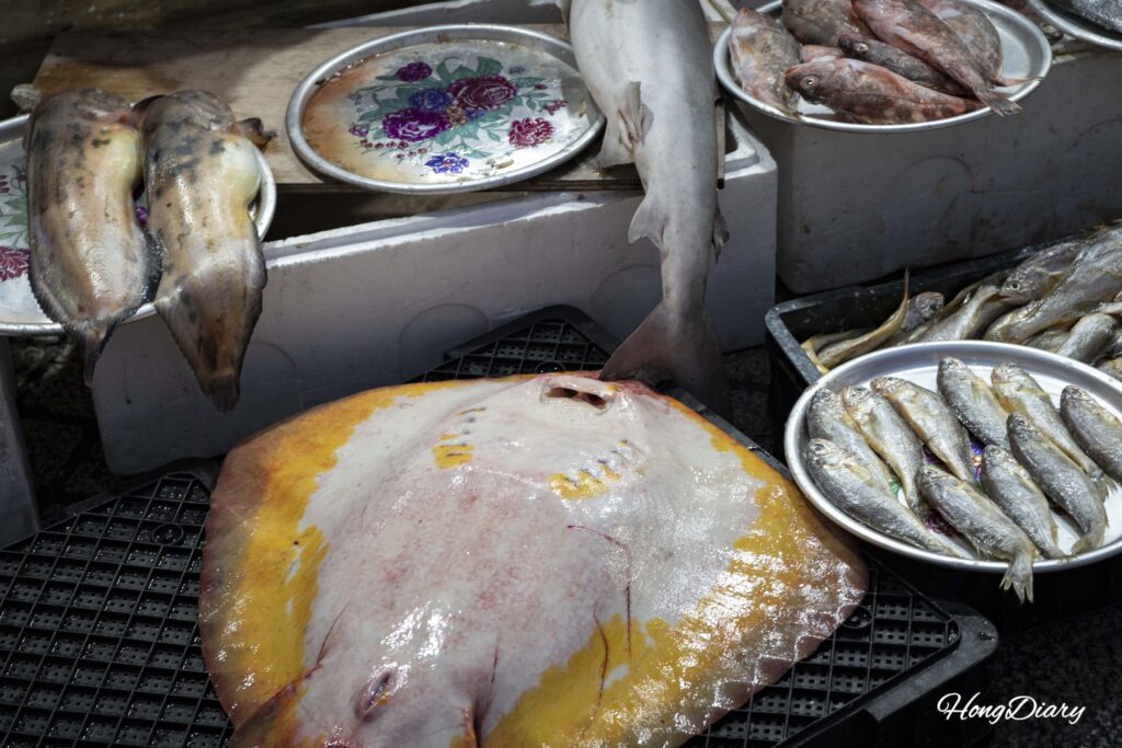 Fresh seafood display at a vendor stall inside Jinju Jungang Market, Gyeongsangnam-do