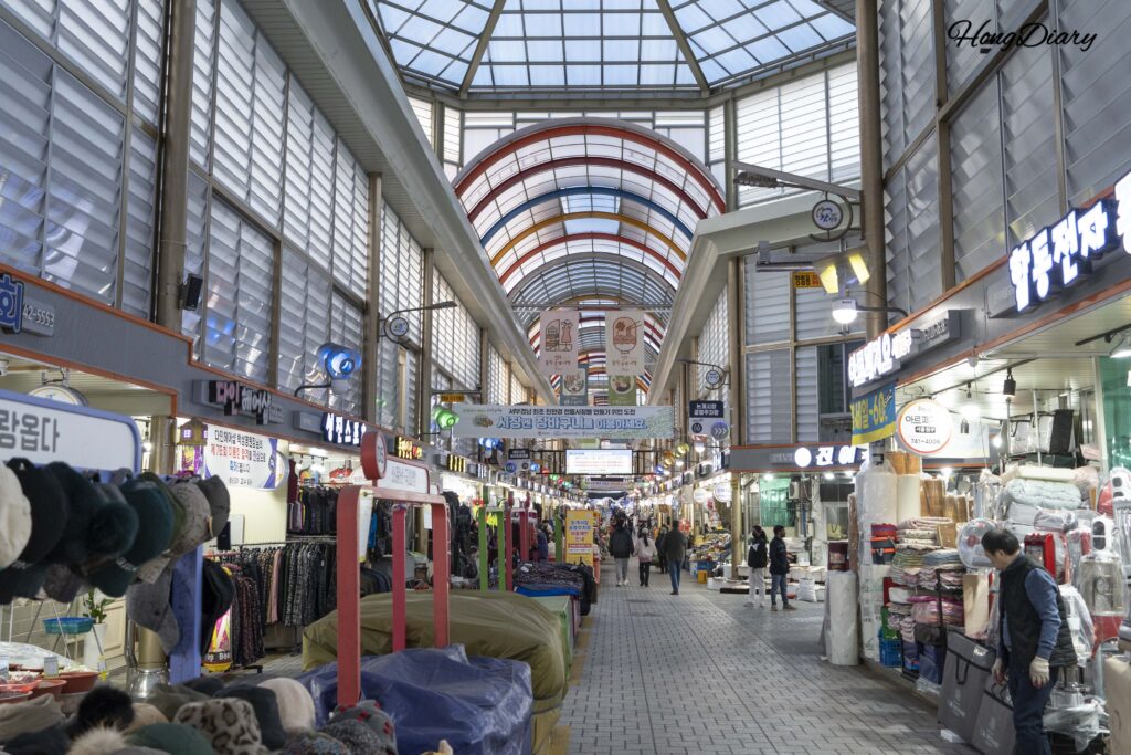 Vendors and shoppers inside the covered arcade of Jinju Jungang Market in Jinju, South Korea