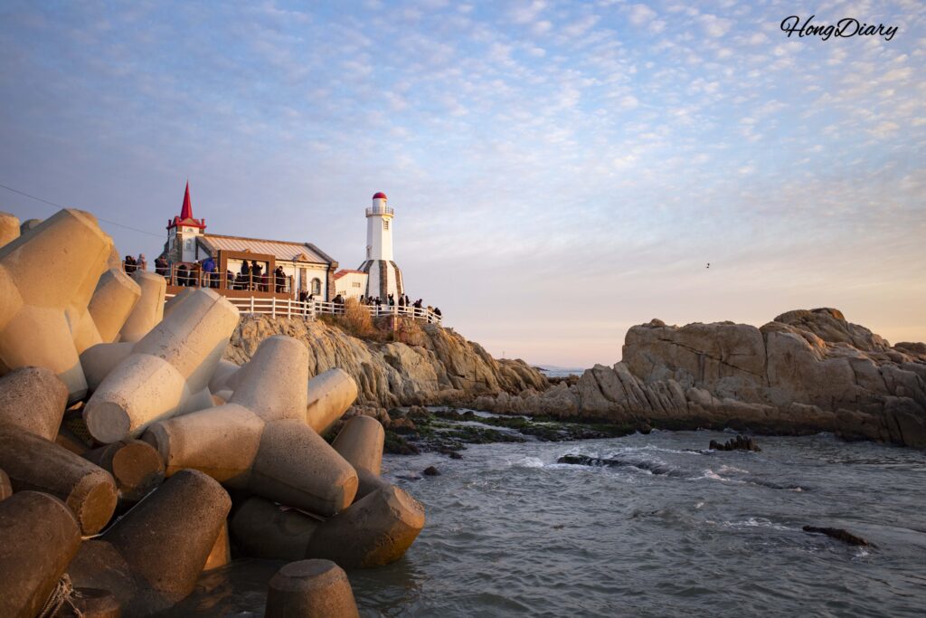 Tourists photographing Jukseong Church from the tetrapods on New Year's morning, Busan